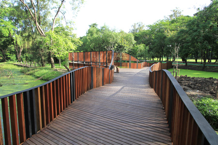Wooden walkway with handrail in the parkの写真素材