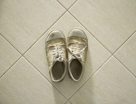 Top view of old sneakers on tiled floorの写真素材