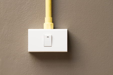 Switch installed on dark brown wall