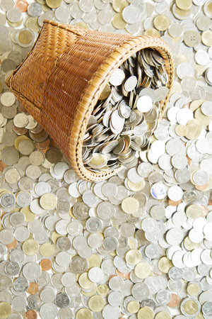 Saving money concept of collecting coins in a basket with coins background. as background business concept and Saving concept.の写真素材