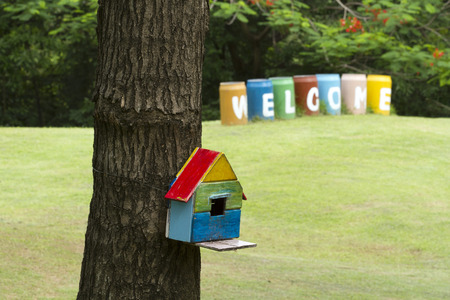 Bird house nesting-box hang on tree trunk