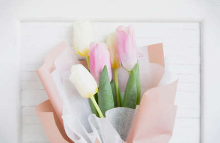 Bouquet of tulip over white wooden frame.の写真素材