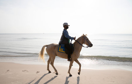 PRACHUAP KHIRI KHAN, THAILAND- April, 15, 2021 :Unidentified people riding a horse by the beach at morning sunrise at Huahin beach of Prachuap Khiri Khan,Thailand.のeditorial素材