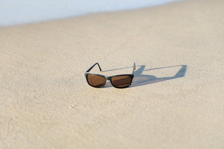 Sunglasses with shawdow on the sandy beach