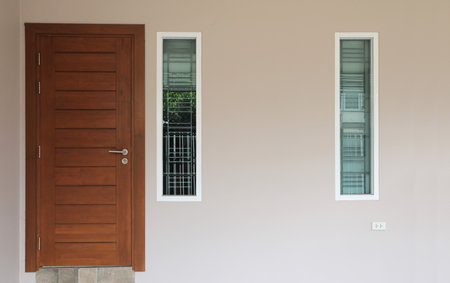 Exterior of a house with wooden door and windowsの写真素材