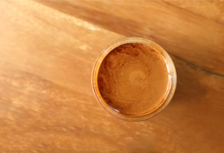 Dirty coffee cup on wooden table.の写真素材