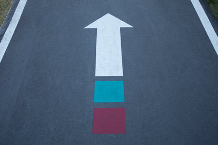 White arrow sign with green and red on the end.の写真素材