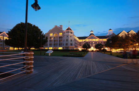 Illuminated resort and wooden boardwalk at nightのeditorial素材