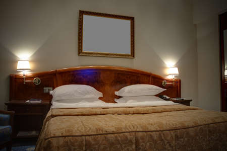 King-size bed with bedside tables and lamps 