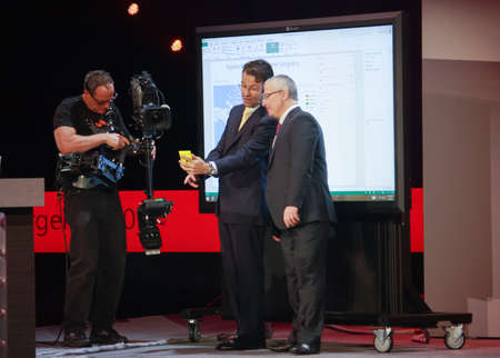 ATLANTA, GA, USA, MARCH 4, 2014 - Microsoft President North America Judson Althoff demonstrates mobile application to Microsoft Vice President Kirill Tatarinov  right  at Microsoft Convergence conference on March 4, 2014 in Atlanta, GAのeditorial素材