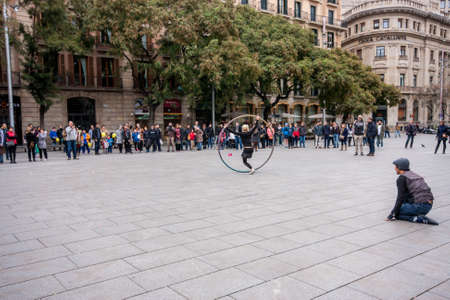 BARCELONA, SPAIN - FEB 9, 2014: Acrobat with hoop make performance at city square on Feb 9, 2014 in...