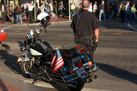 SAN FRANCISCO, USA - SEPT 24, 2008: US policeman patrols city street crowded by attendees of Oracle OpenWorld conference on Sept 24, 2008 in San Francisco, USA. 40,000 specialists visited this forumのeditorial素材
