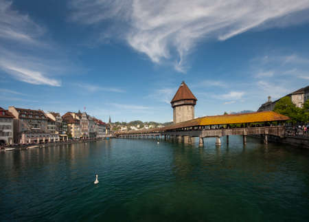 LUCERNE, SWITZERLAND - APRIL 20, 2014: A view of the famous wooden Chapel Bridge with the Water Tower and Reuss River in Lucerne on April 20, 2014. It is restored after a fireのeditorial素材