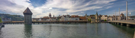 LUCERNE, SWITZERLAND - APRIL 20, 2014: Panoramic view of famous wooden Chapel Bridge with the Water Tower and Reuss River in Lucerne on April 20, 2014. Bridge is restored after a fire in august 1993のeditorial素材