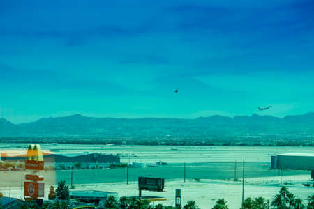 LAS VEGAS, NEVADA, USA - JUNE 11, 2013: Runway of McCarran airport with airplane and helicopter climb after take off in Las Vegas on June 11, 2013.のeditorial素材