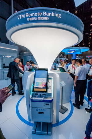 SHANGHAI, CHINA - AUGUST 31, 2016: Attendees look at VTM Remote Banking appliance at Huawei Connect 2016 information technology conference and exhibition in Shanghai, China on August 31, 2016.のeditorial素材