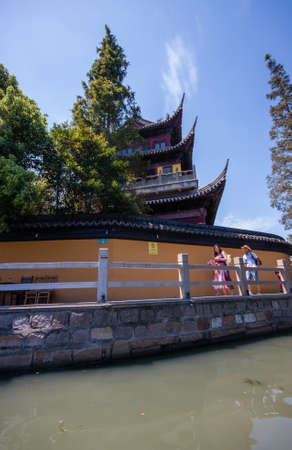 ZHUJIAJIAO, CHINA - AUGUST 30, 2016: Tourists see the sights of ancient water town with a history of more than 1700 years near Yuanjin Buddhist temple in Zhujiajiao, China, on August 30, 2016.のeditorial素材