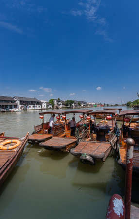 ZHUJIAJIAO, CHINA - AUGUST 30, 2016: Chinese gondolas waits Tourists on canal of ancient water town with a history of more than 1700 years in Zhujiajiao, China, on August 30, 2016.のeditorial素材
