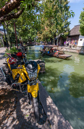 ZHUJIAJIAO, CHINA - AUGUST 30, 2016: Boatman transports tourists by Chinese gondola on canal of ancient water town with a history of more than 1700 years in Zhujiajiao, China, on August 30, 2016.のeditorial素材