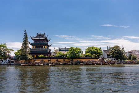 ZHUJIAJIAO, CHINA - AUGUST 30, 2016: Tourists see the sights of ancient water town with a history of more than 1700 years near Yuanjin Buddhist temple in Zhujiajiao, China, on August 30, 2016.のeditorial素材