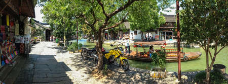 ZHUJIAJIAO, CHINA - AUGUST 30, 2016: Boatman transports tourists by Chinese gondola on canal of ancient water town with a history of more than 1700 years in Zhujiajiao, China, on August 30, 2016.のeditorial素材