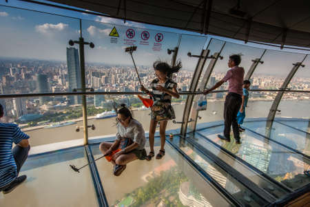 SHANGHAI, CHINA - AUGUST 29, 2016: An unidentified people take selfie photo on transparent glass...