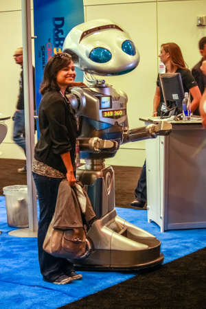 SAN FRANCISCO, CA, US - OCT 3, 2012: Unidentified woman stands near robot at booth of Dun and Bradstreet company at exhibition of Oracle OpenWorld conference in San Francisco on October 3, 2012.のeditorial素材