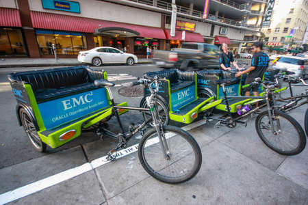 SAN FRANCISCO, USA - OCT 1, 2012: Unidentified young trishaw drivers wait attandees of Oracle OpenWorld conference on downtown street in San Francisco on Oct 1, 2012.のeditorial素材