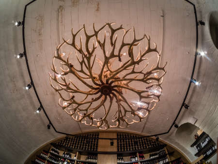 MOSCOW, RUSSIA - MAY 31, 2017: Luster made of deer antlers in collection of vintage wines room in...