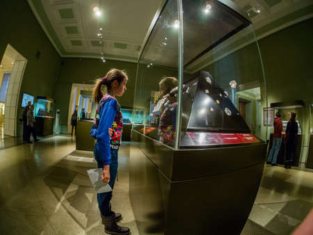 MOSCOW, RUSSIA - JAN 14, 2020: Schoolgirl studies the archaeological finds exposition of the...