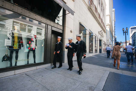 SAN FRANCISCO, USA - OCT 1, 2012: Three US Navy sailors on leave in dark uniform walk down the street on Oct 1, 2012 in San Francisco, USA.のeditorial素材