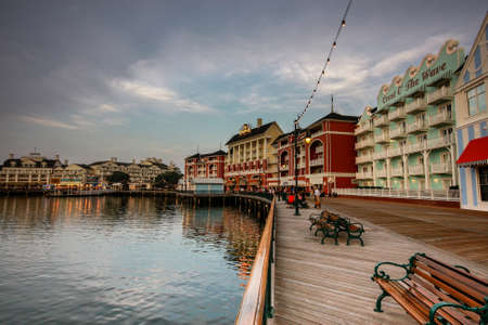 ORLANDO, FL, USA - JUNE 6, 2011: People are walking along wooden embankment at Boardwalk Disney  area on Crescent Lake shore at twilight in Orlando on June 6, 2011.のeditorial素材