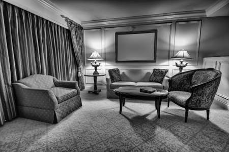 Classic sitting room with sofa, armchair, table and lampsの写真素材