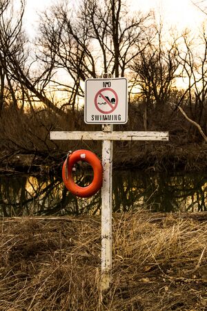 No swimming sign on white board and cross.の写真素材