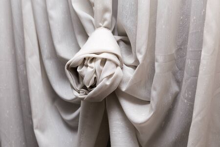 Beautiful curtain with decorative knot on window.の写真素材