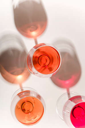 Glasses of white and pink wineの写真素材
