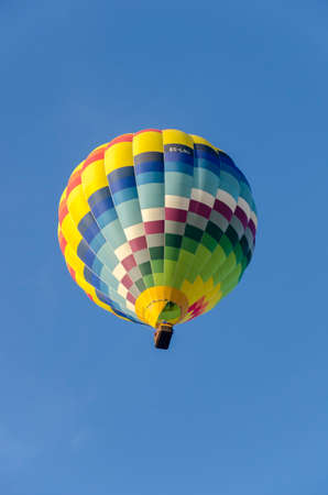Multicolored hot air balloon seen from the groundの写真素材