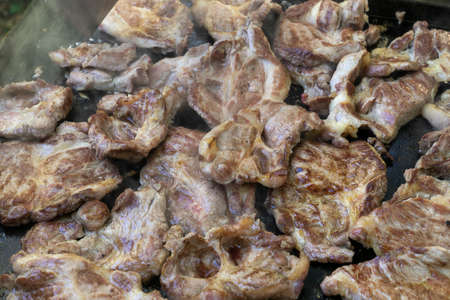 Close up of pork steaks during the grillの写真素材