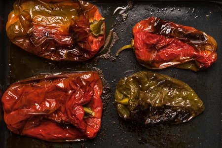 Flat lay of roasted red and green peppers ready to be servedの写真素材