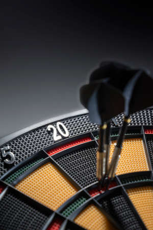Close up of three darts in triple 20 of dartboard.Ton 80. Black Dartsの写真素材