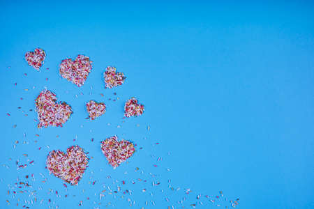 Multicolored confectionery noodle hearts on blue background. St. Valentine's Day. Weddings, Anniversary, Mother's Day. Backgroundの写真素材