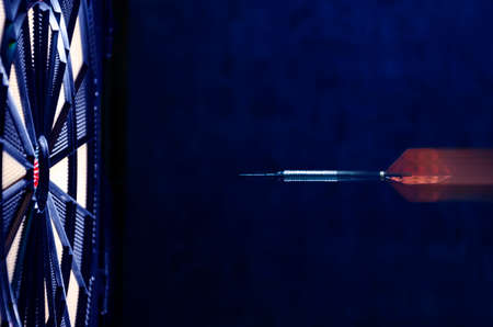 Orange dart moving towards the bullseyeの写真素材
