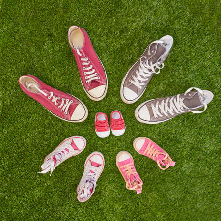 Flat lay of pregnancy announcement with colored sneakersの写真素材