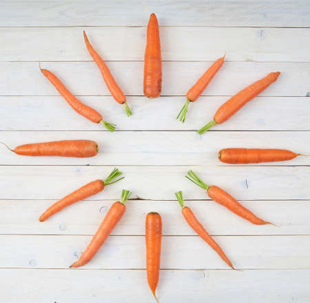 Top view of vegetables for posters and healthy food menus on white wooden background. Organic agricultural products. Vegan food. Veggies. Fresh vegetablesの写真素材