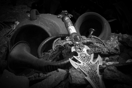 Photo of cold steel against the background of natural stones.の写真素材