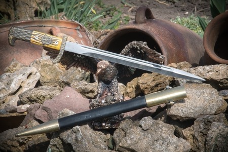 Photo of cold steel against the background of natural stones.の写真素材