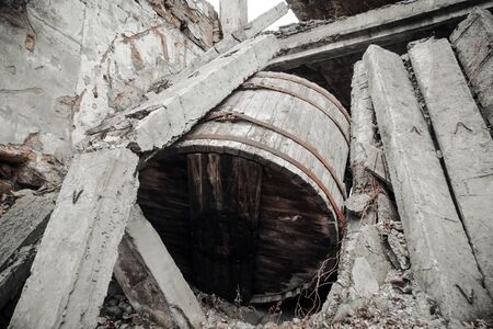Ukraine, Odessa area destroyed factory. A huge wooden barrel, capacity, and the ruins of the destroyed building or premises.の写真素材