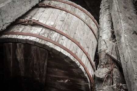 Ukraine, Odessa area destroyed factory. A huge wooden barrel, capacity, and the ruins of the destroyed building or premises.の写真素材
