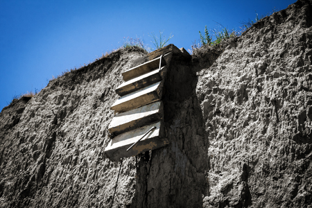 Broken old ladder rock cliffの写真素材