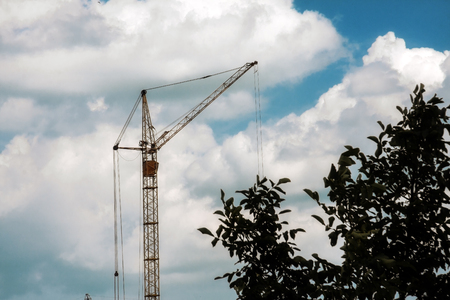 Construction crane against the sky with beautiful clouds.の写真素材